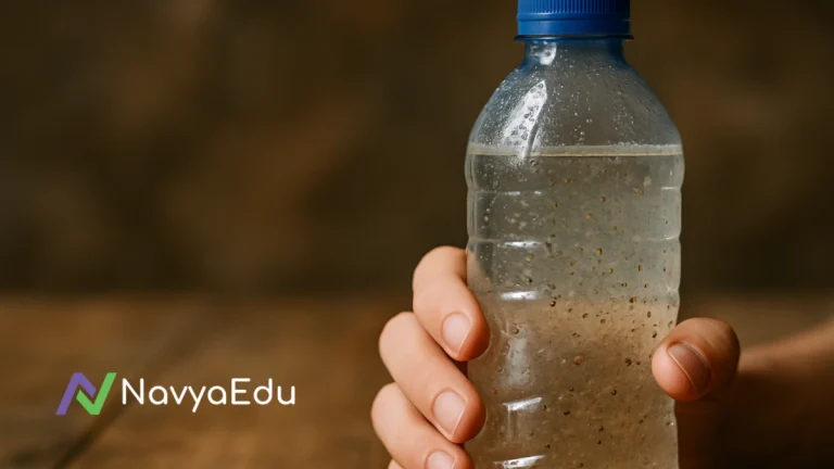 Close-up of a hand holding a plastic bottle with murky water and floating particles